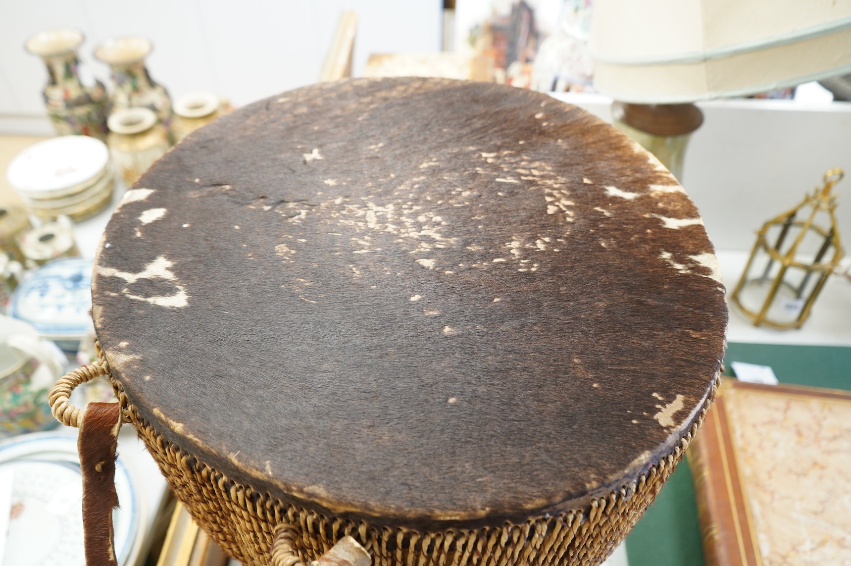 An African drum with a hide skin and gut stretchers, the body of the drum also covered with hide, diameter of the drum 46cm, the height 60cm